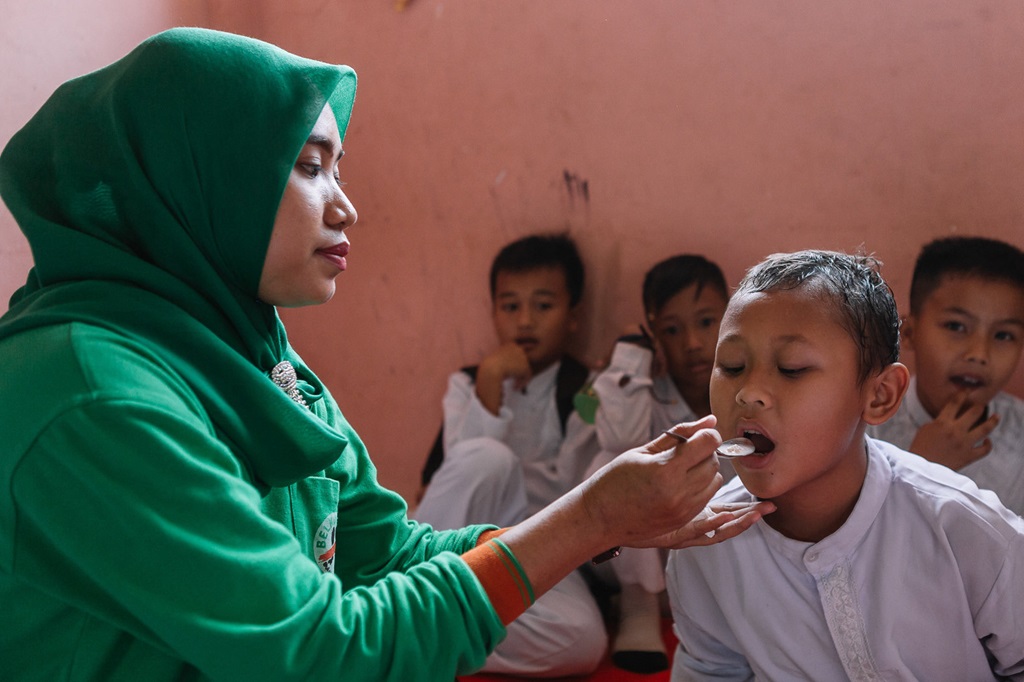 A child receives a dose of medication during a mass drug administration for the elimination of lymphatic filariasis in South Sumatra. A child receives a dose of medication during a mass drug administration for the elimination of lymphatic filariasis in South Sumatra.