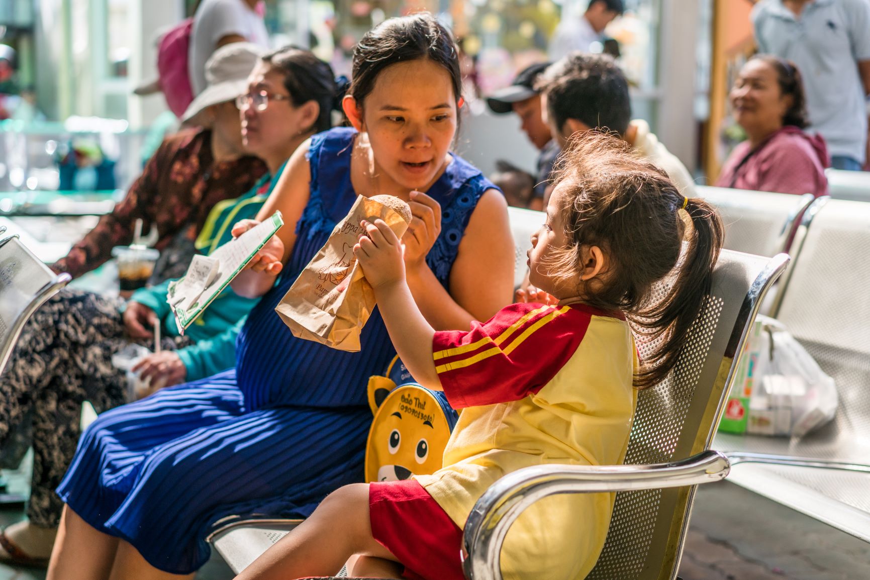 Mother and daughter inside a community clinic