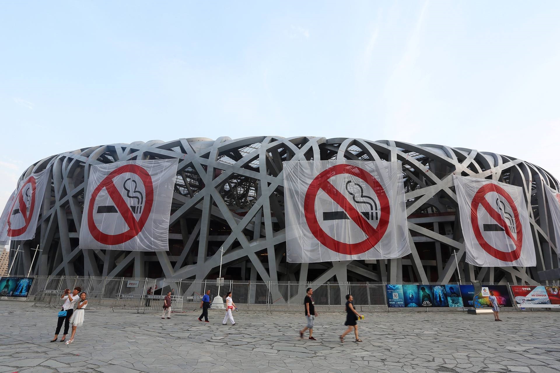 Tobacco No smoking banners on a large building shaped like a bird's nest in China