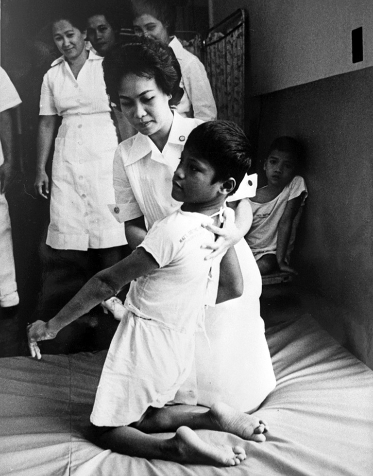 1960s A student nurse attends to a cerebral polio patient. She is part of UP Manila’s physiotherapy course.