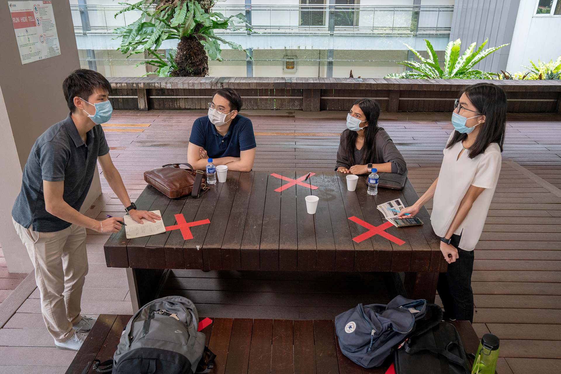 TIMOTHYLIAU_REDIT_WHO_0054 (From left) Timothy Liau brainstorms with teammates from Mind Hacks Low Jia Eu, Bhawana Sapkota and Lee Yiu Kui Rachel about mental health awareness initiatives at the Singapore Polytechnic Cafe.